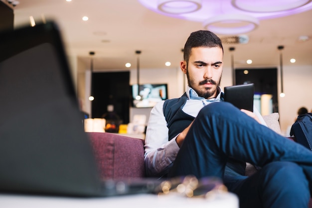 Serious young man concentrated on phone