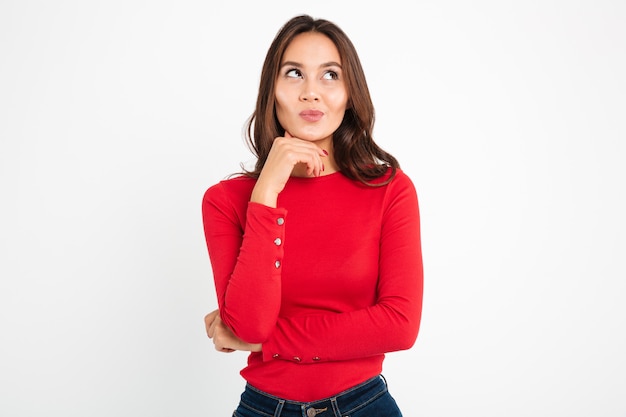 Serious young woman thinking.