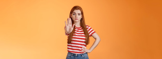 Seriouslooking confident brave redhead girl oppose haters fighting for freedom prohibit illegal acti