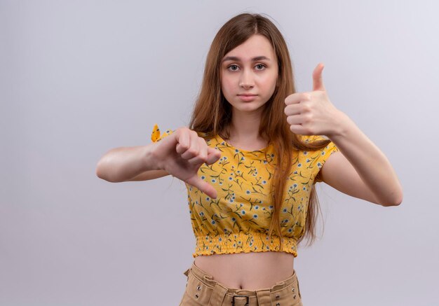 Seriously looking young girl showing thumbs up and down 