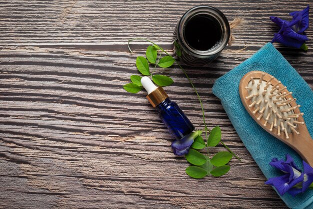 Serum bottle of Butterfly Pea Flower oil put on wooden background