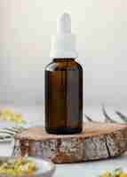 Free photo serum bottle on wooden piece