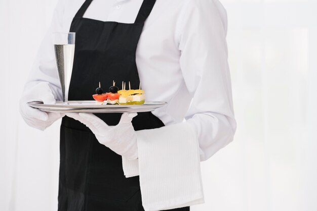 Servant in uniform holding a tray