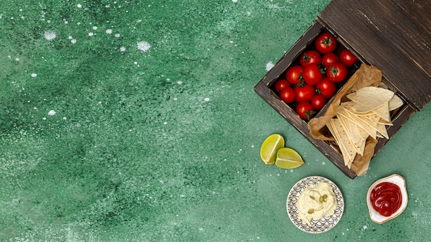 Served tortilla with dips and tomatoes