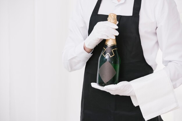 Server holding bottle of champagne