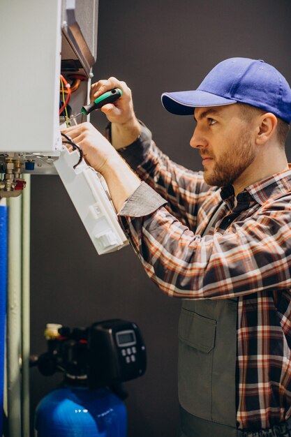 Service man adjusting house heating system