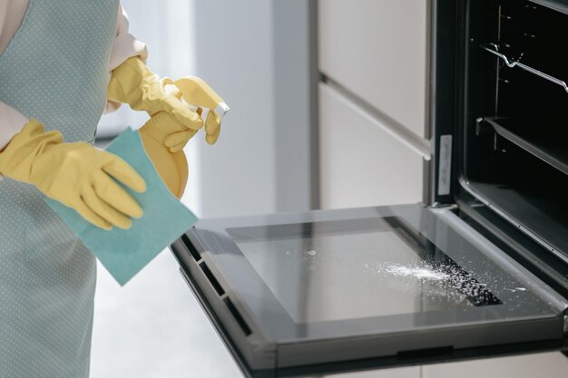 Service person cleaning the kitchen appliances