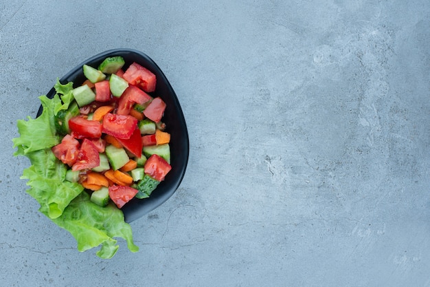 Serving of shepherd's salad on marble.