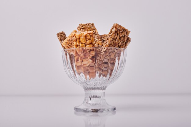 Sesame and nut crackers in a glass cup.