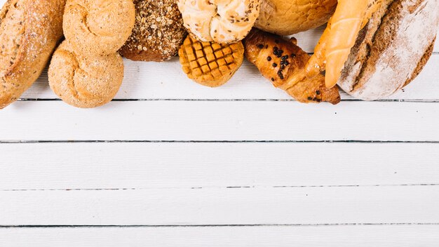 Set of baked bread on wooden white table