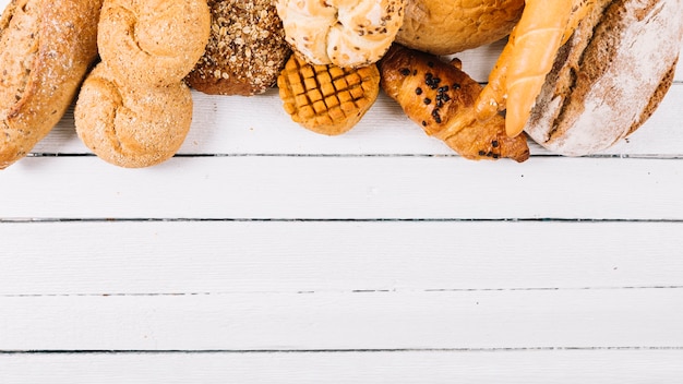 Set of baked bread on wooden white table