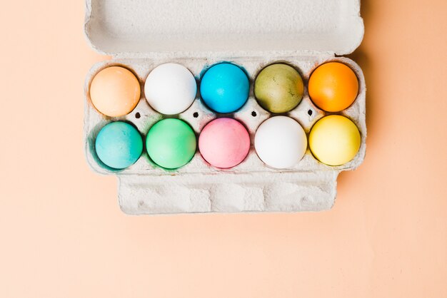 Set of bright Easter eggs in container