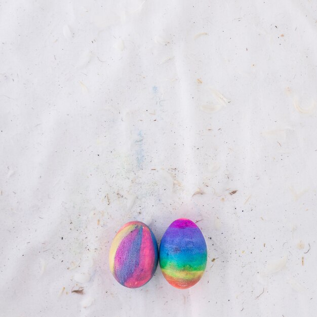 Set of bright Easter eggs and feathers on textile