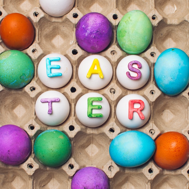 Free photo set of bright eggs in container with easter title