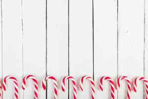 Free photo set of candy canes on wood desk