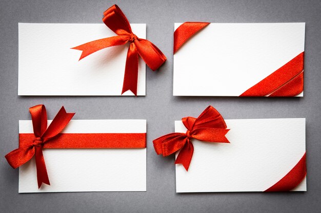 Set of cards with red ribbons bows
