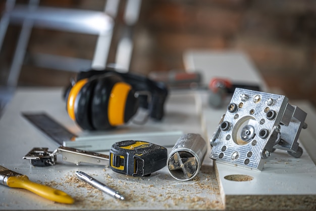 A set of carpenter's tools, accessories for precision drilling and wood measurement.
