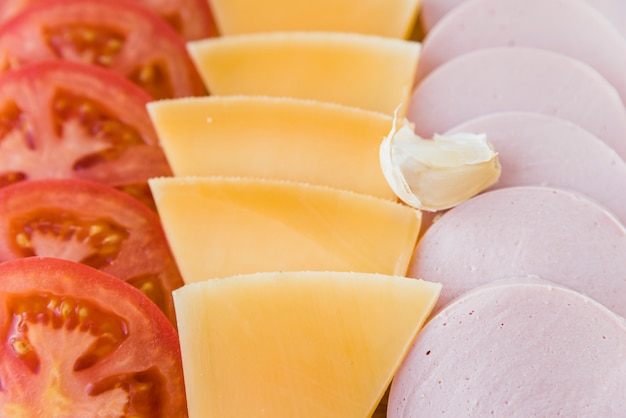 Foto gratuita set di formaggio vicino a pomodori e carne per il pranzo