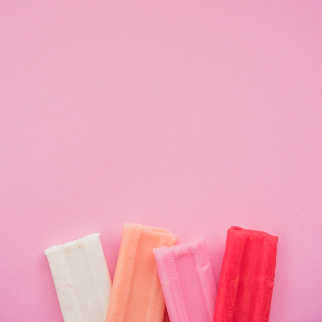 Set of colorful clay bar on pink background