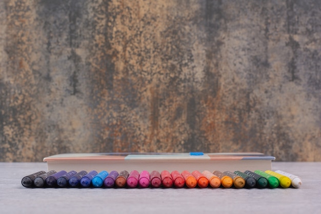 Set of colorful pencils on white table.