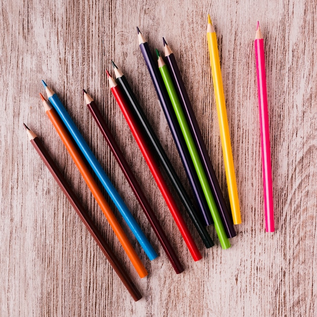 Free photo set of colour pencils on wooden surface