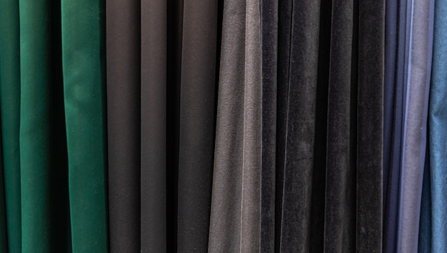 Set of dark multi-colored dense fabrics of uniform texture, choice of materials in different colors.