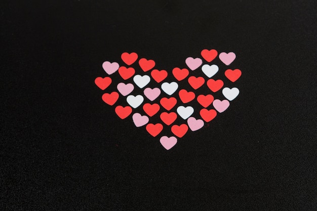 Set of decorative hearts on dark board 