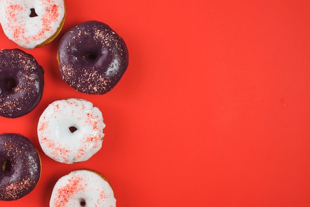 Set of different colored round frosted donuts