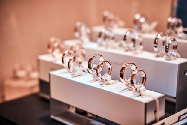 Set of different gold rings on the showcase of a luxury jewelry store, Close-up photo