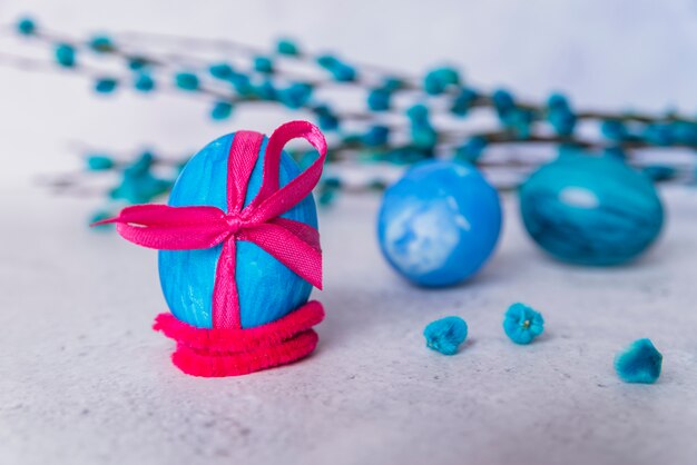 Set of Easter eggs in band with hair tie and plant twigs