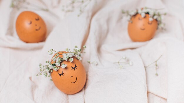 Set of Easter eggs with decorative flower wreaths between textile