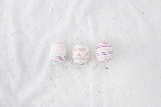 Set of Easter eggs with patterns and feathers on textile