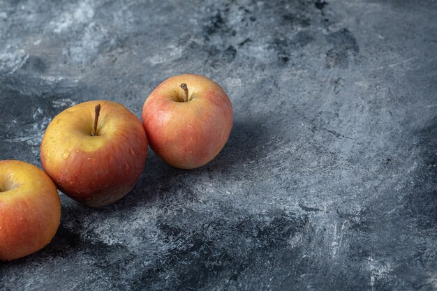 Set of fresh red yellow apple on marble background.