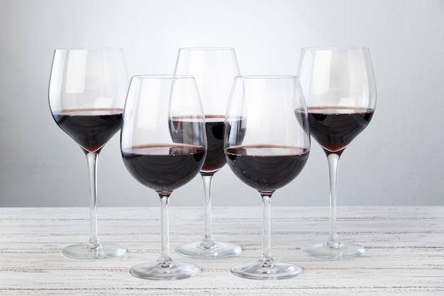 Set of glasses with red wine on table