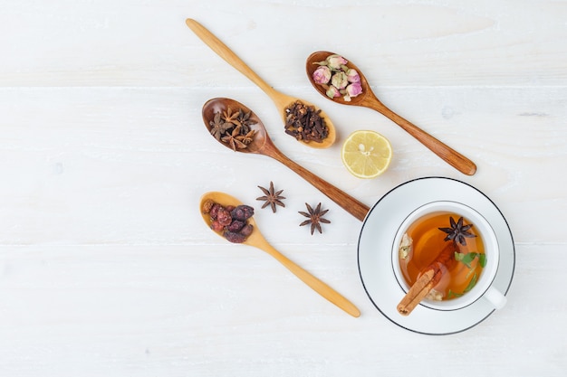 Free photo set of herbs and spices and herbal tea on a white surface