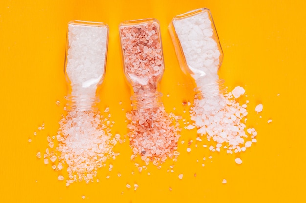 Free photo set of himalayan salt and sea salt coming out of salt shakers