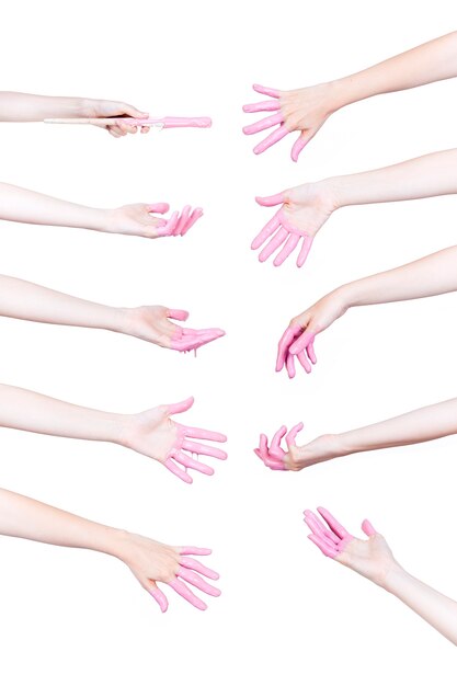 Set of human hands with pink paint on white background