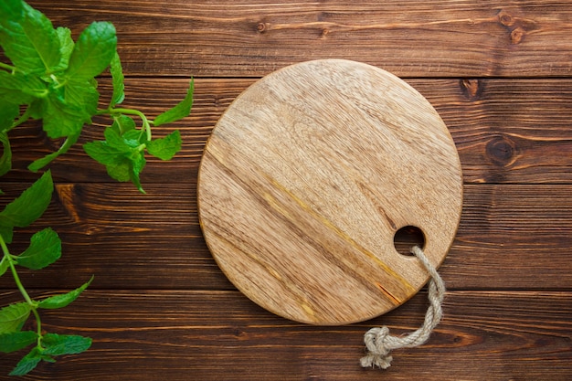 Set of leaves and cutting board on a wooden background. top view. copy space for text