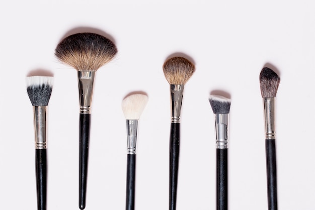 Set of makeup brushes on white