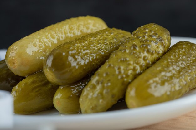 Set of marinated cucumbers on white plate