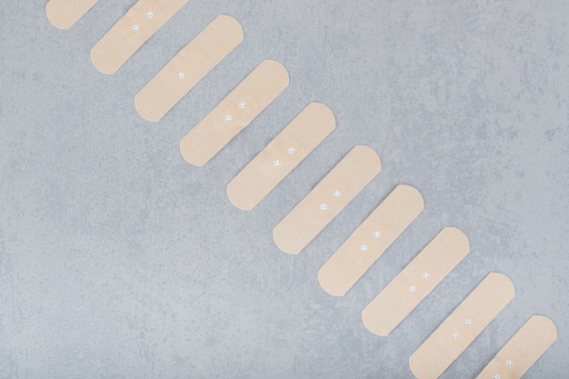 Free photo set of plasters on a gray surface