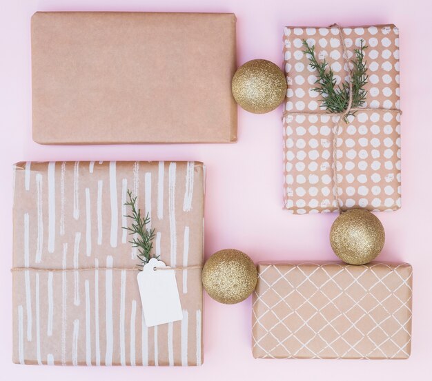 Set of present boxes in wraps near Christmas balls 