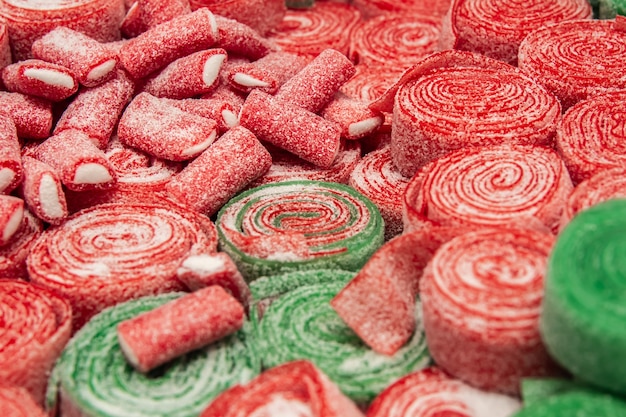 Set of red and green rolled chewing candies close up