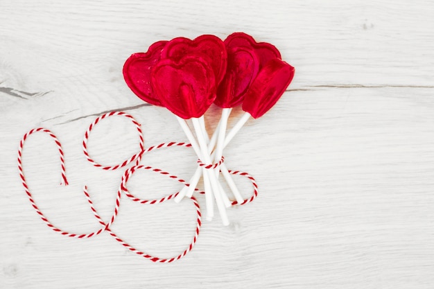 Set of red lollipops on sticks with thread 