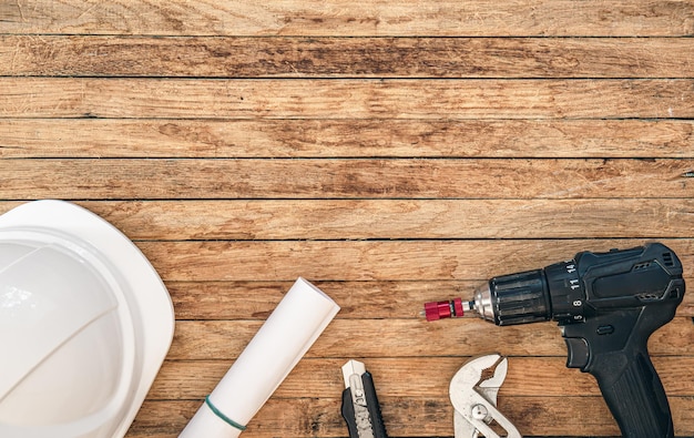 Free photo set of repair tools on wooden background flat lay