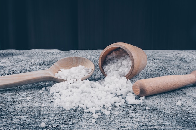 Set of rolling pin and sea salt in a bowl and spoon