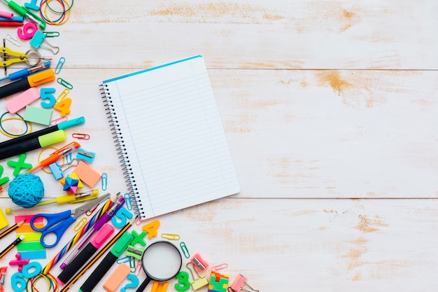 Set of school supplies on white wooden background