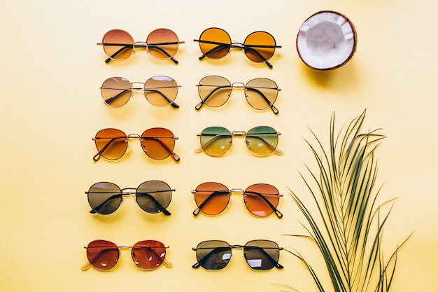 Set of sunglasses on yellow background isolated