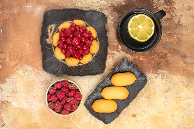 Set table with a gift cake and a cup of tea with lemon on mixed color table footage