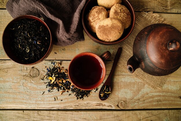 Set of teapot and cups on wooden background